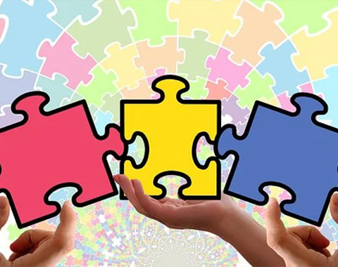 Hands grasping vibrant puzzle pieces, colorful backdrop, symbolizing creativity and problem-solving.