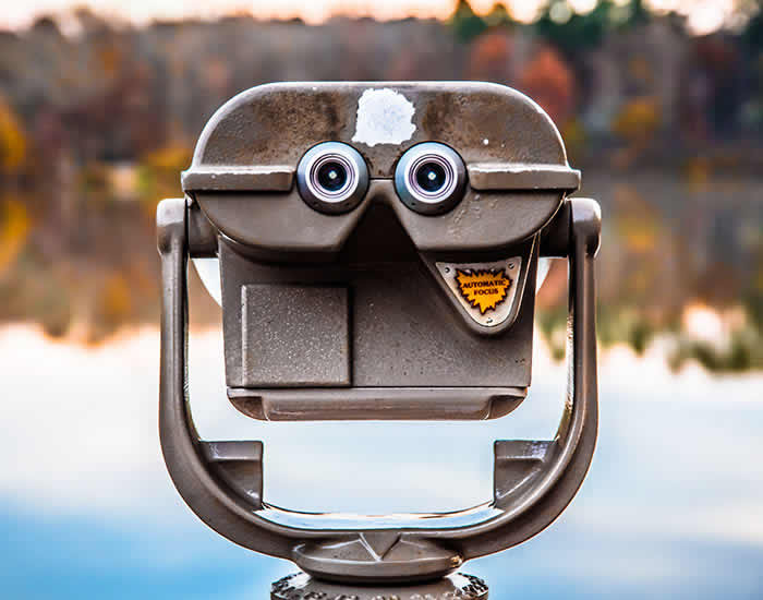 A coin-operated binoculars featuring large googly eyes presenting Vision of Attentive Care